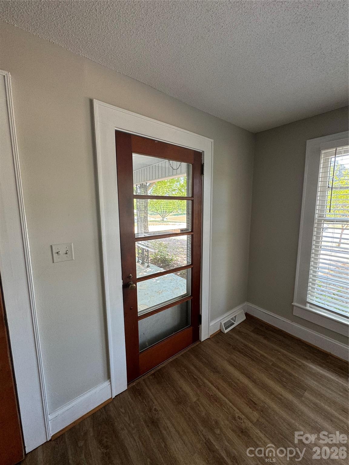 509 East Main Street Locust, NC 28097 - Photo 4 of 40 an empty room with wooden floor closet and windows