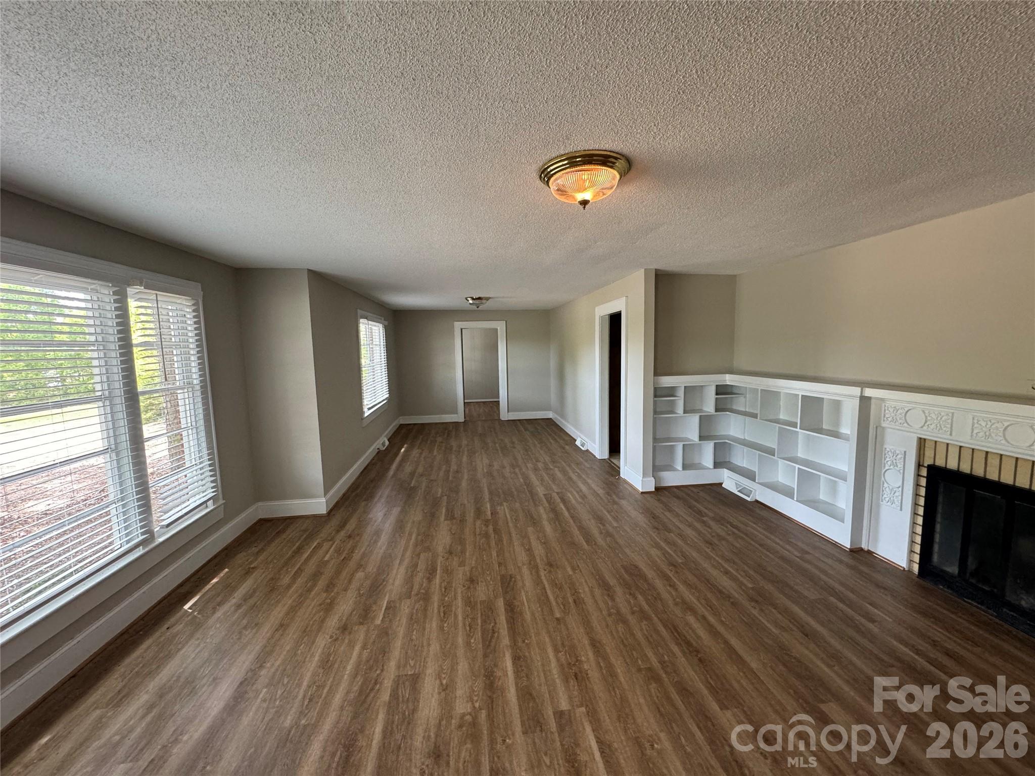 509 East Main Street Locust, NC 28097 - Photo 5 of 40 wooden floor in an empty room with a window