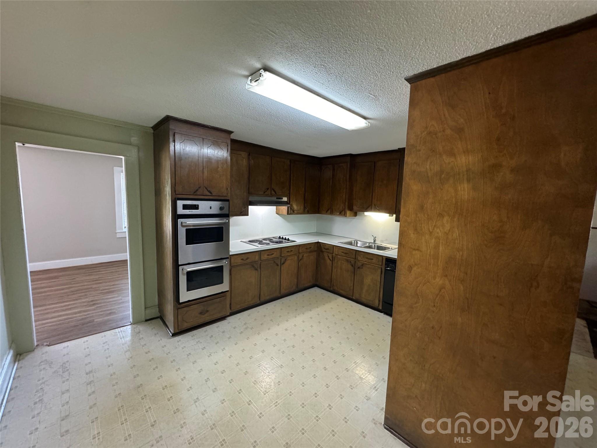 509 East Main Street Locust, NC 28097 - Photo 10 of 40 a kitchen with stainless steel appliances granite countertop a refrigerator and a stove