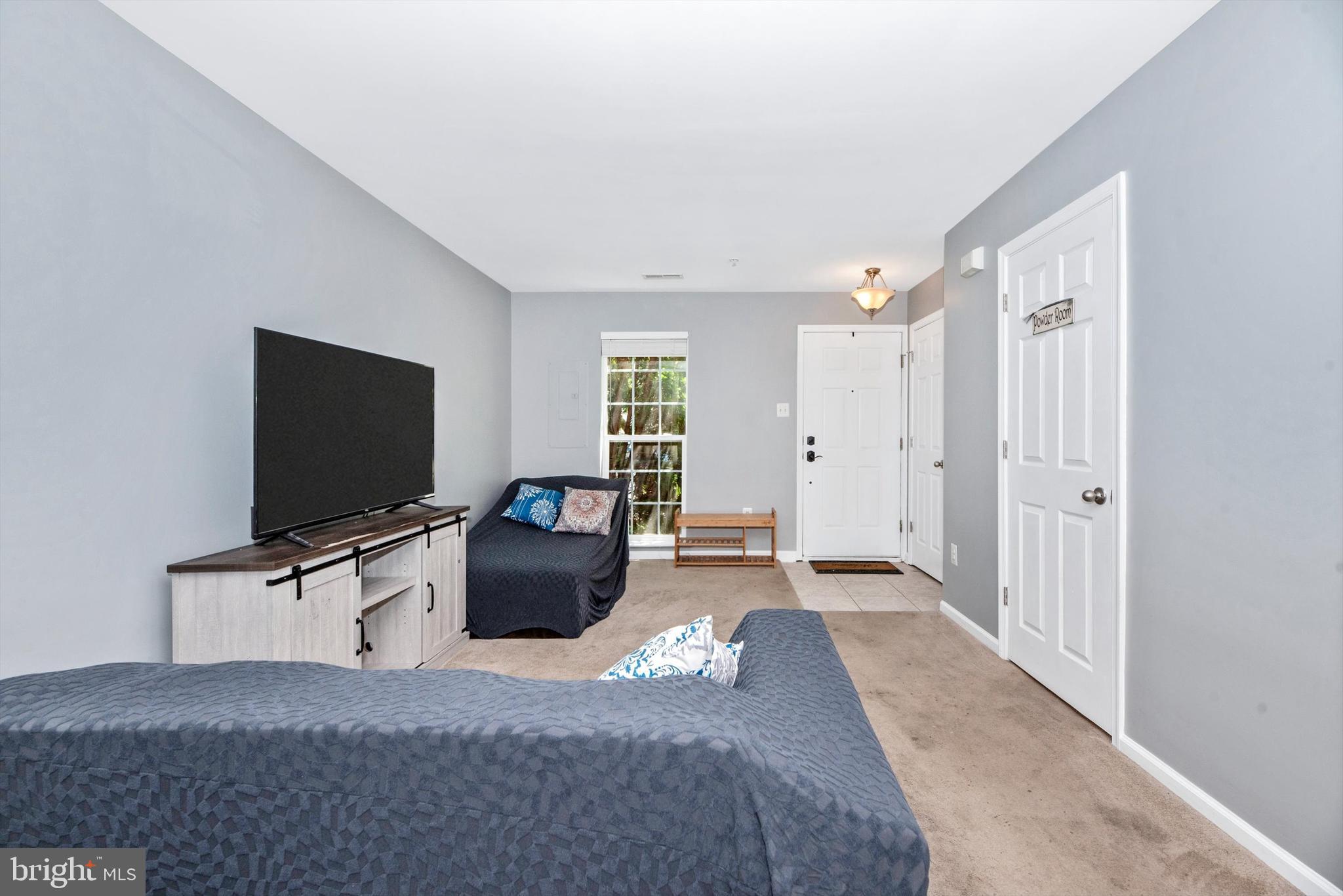 605 Tivoli Road Frederick, MD 21703 - Photo 4 of 35 a bedroom with furniture and a flat screen tv