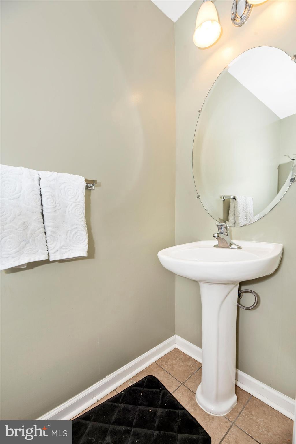 605 Tivoli Road Frederick, MD 21703 - Photo 9 of 35 a bathroom with a sink a mirror and a
