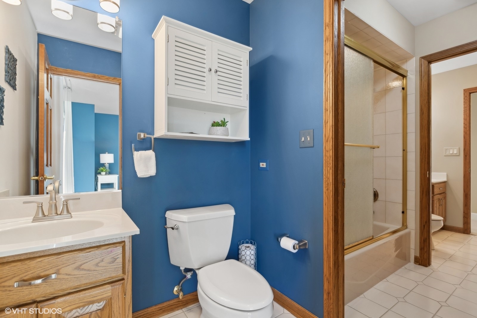 321 Ridge Lane Lake In The Hills, IL 60156 - Photo 27 of 46 a bathroom with a granite countertop toilet a sink and a mirror
