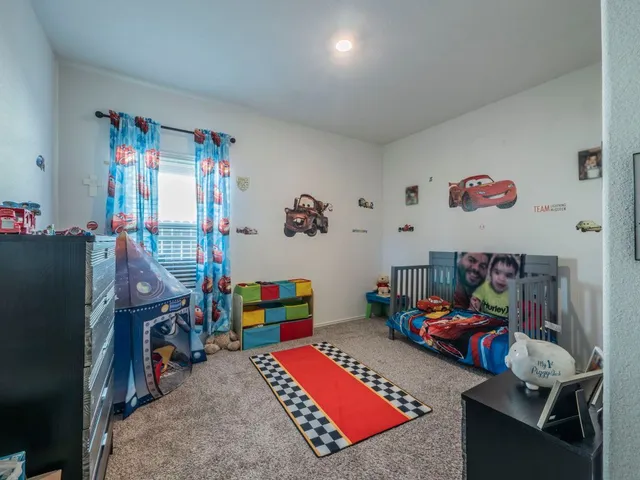 a living room with furniture toys and a flat screen tv