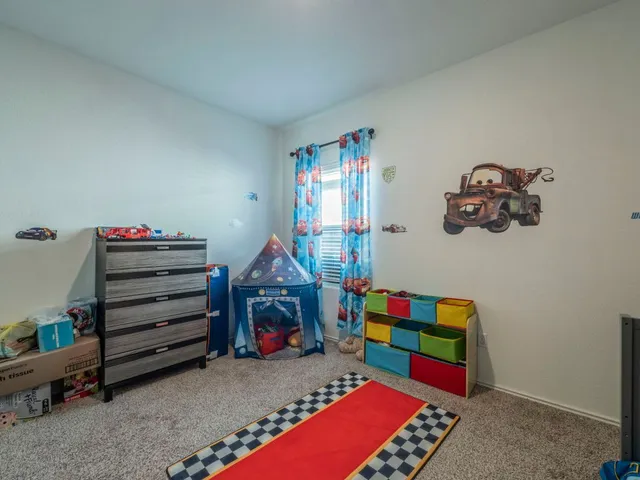 a room with toys and dresser