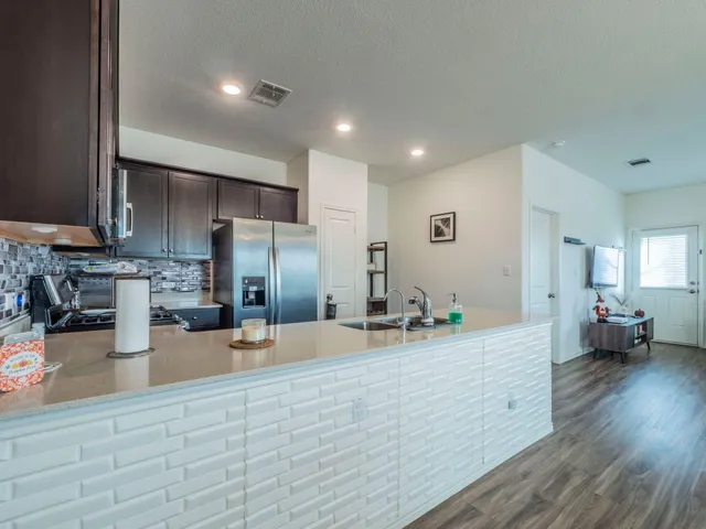 a large kitchen with stainless steel appliances
