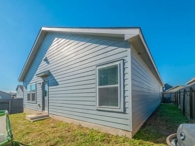a backyard of a house with large trees