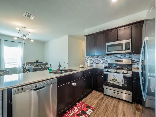 a kitchen with a sink stove and microwave