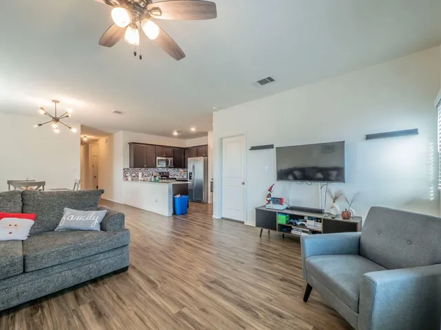 a living room with furniture and kitchen view
