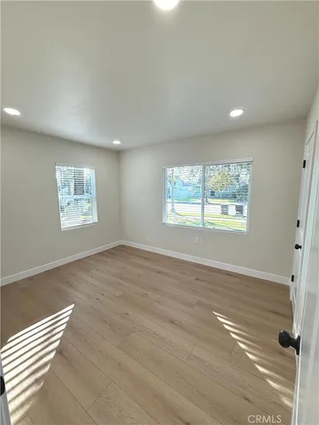 a hallway with wooden floor and entryway