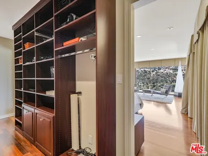 a view of walk in closet with empty racks