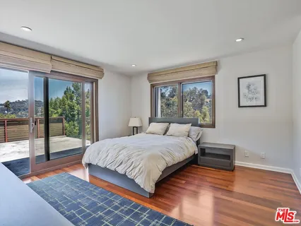 a bedroom with a large bed and a large window