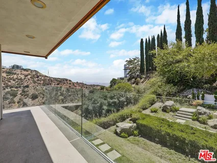 a view of a backyard with sitting area