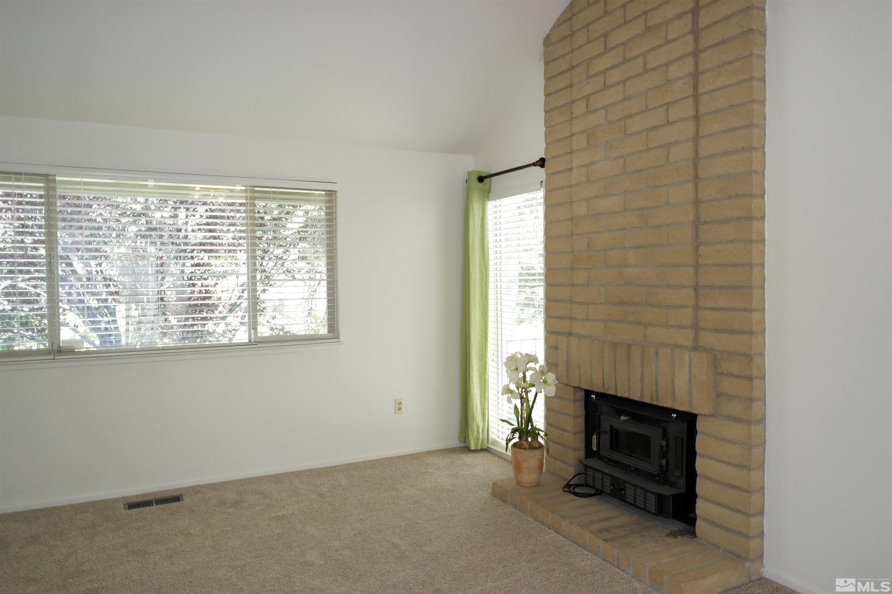 1187 Wagon Wheel Circle Reno, NV 89503 - Photo 12 of 29 a view of an empty room with a fireplace and a window