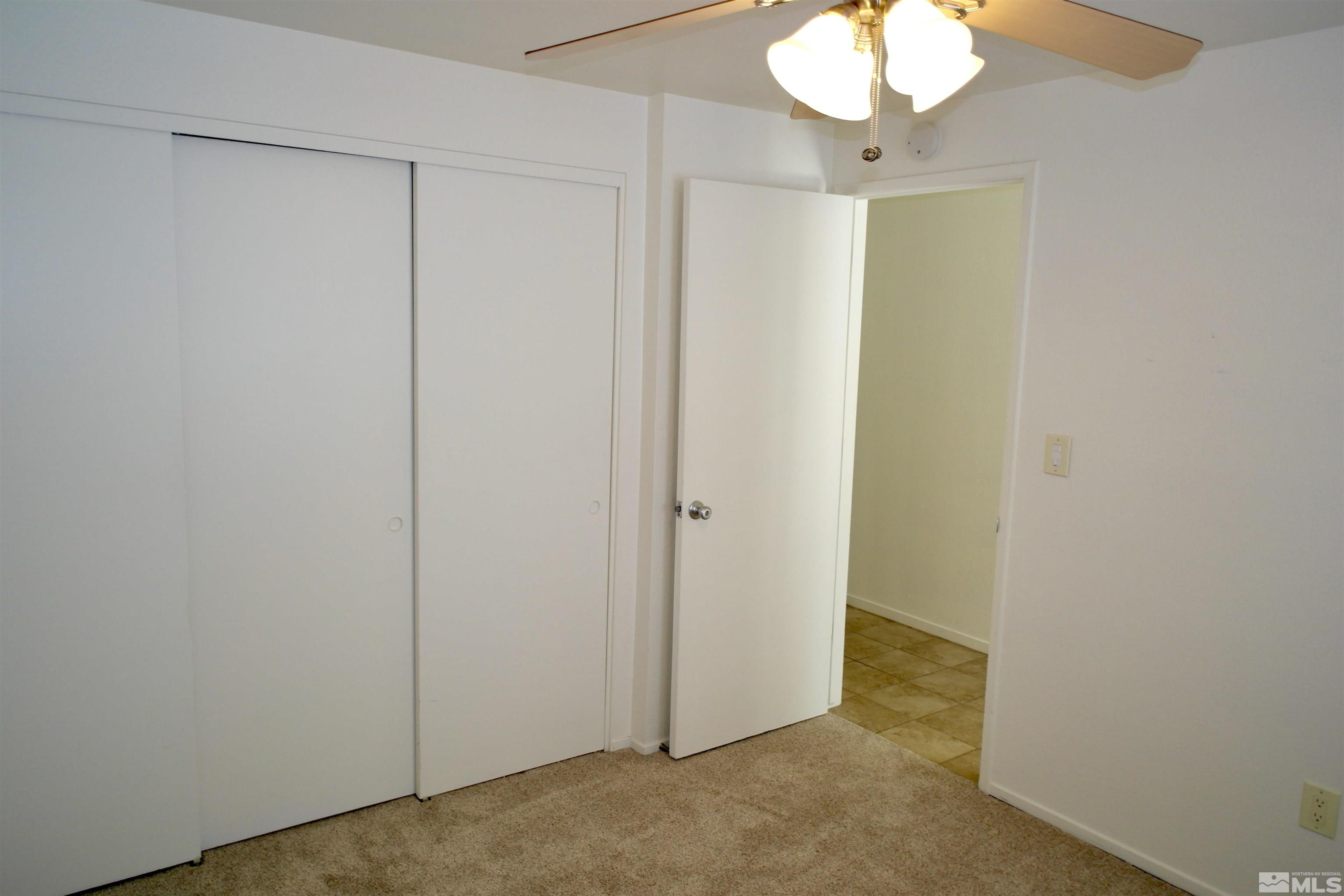 1187 Wagon Wheel Circle Reno, NV 89503 - Photo 19 of 29 a view of a room with a chandelier fan and closet