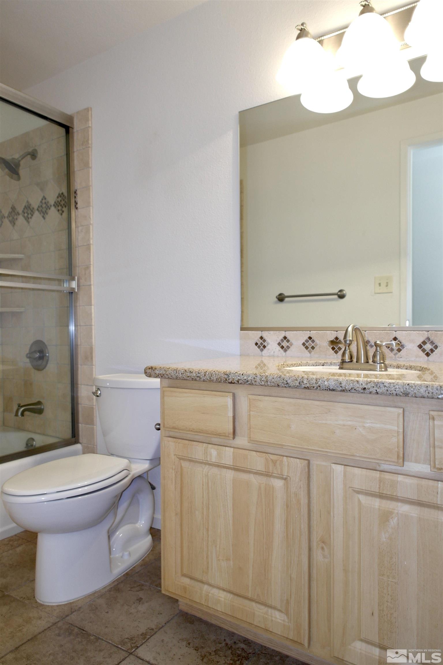 1187 Wagon Wheel Circle Reno, NV 89503 - Photo 20 of 29 a bathroom with a sink a toilet and mirror