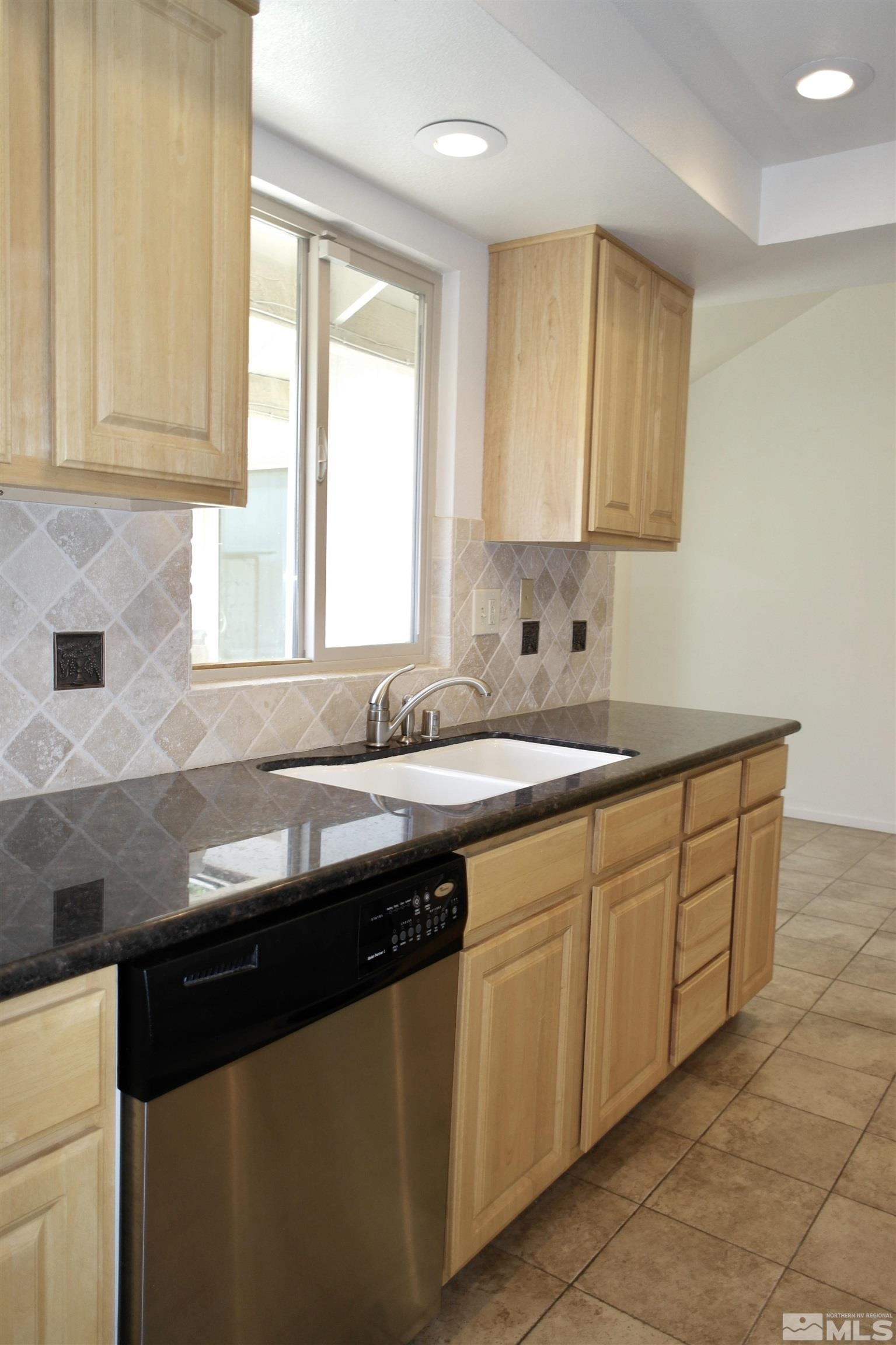 1187 Wagon Wheel Circle Reno, NV 89503 - Photo 6 of 29 a kitchen with granite countertop cabinets sink and window