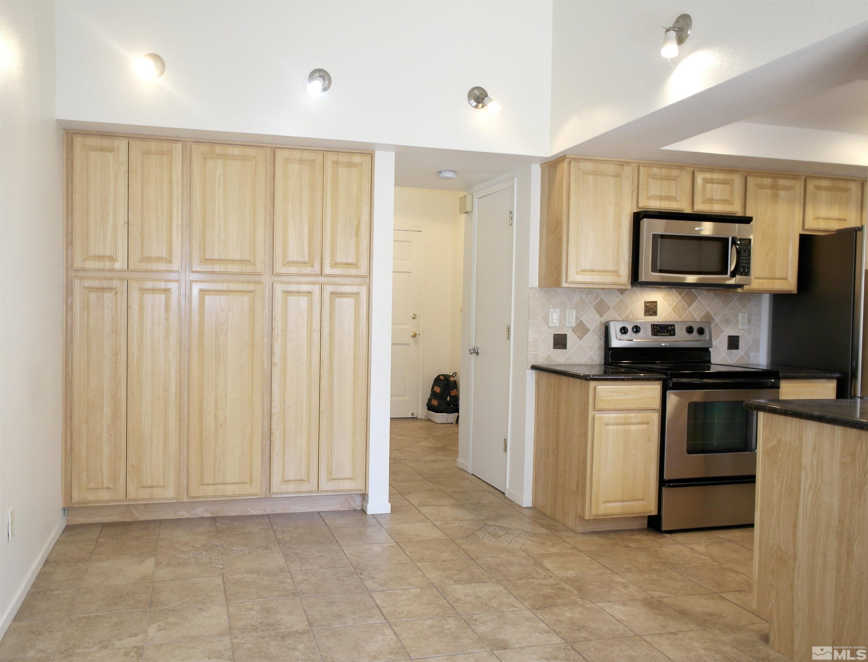 1187 Wagon Wheel Circle Reno, NV 89503 - Photo 7 of 29 a kitchen with granite countertop a refrigerator sink and microwave