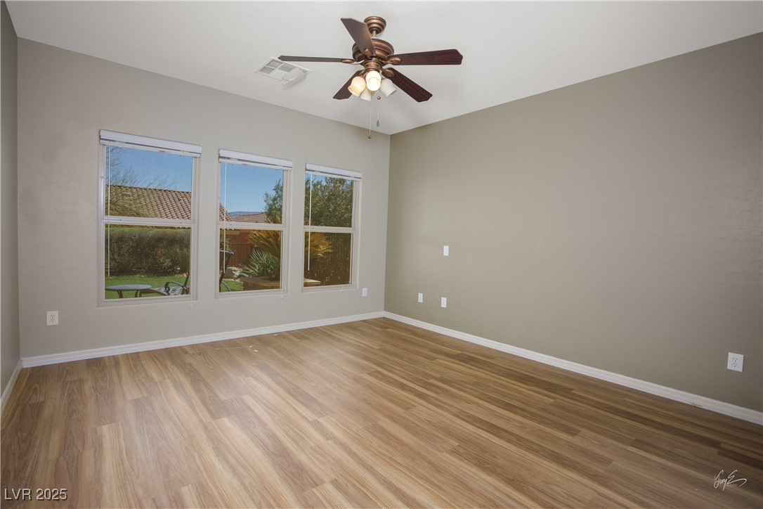 1074 Wagon Trail Mesquite, NV 89034 - Photo 13 of 27 Unfurnished room with a ceiling fan, baseboards, light wood-style floors, and visible vents
