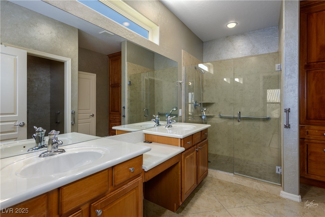 1074 Wagon Trail Mesquite, NV 89034 - Photo 14 of 27 Full bath with a stall shower, tile patterned flooring, and vanity