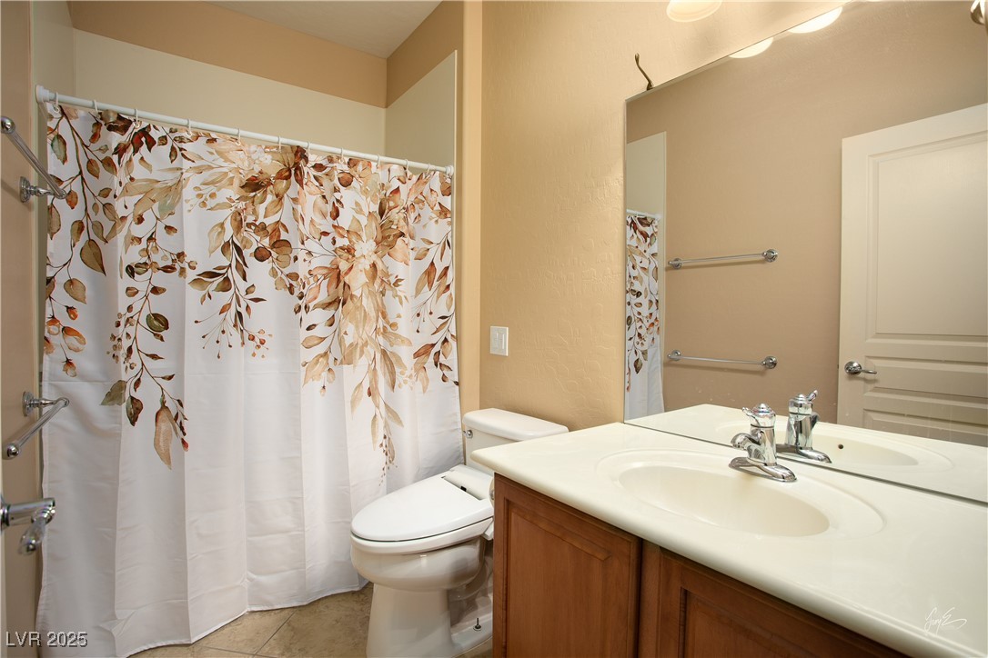 1074 Wagon Trail Mesquite, NV 89034 - Photo 19 of 27 Bathroom featuring tile patterned floors, toilet, and vanity