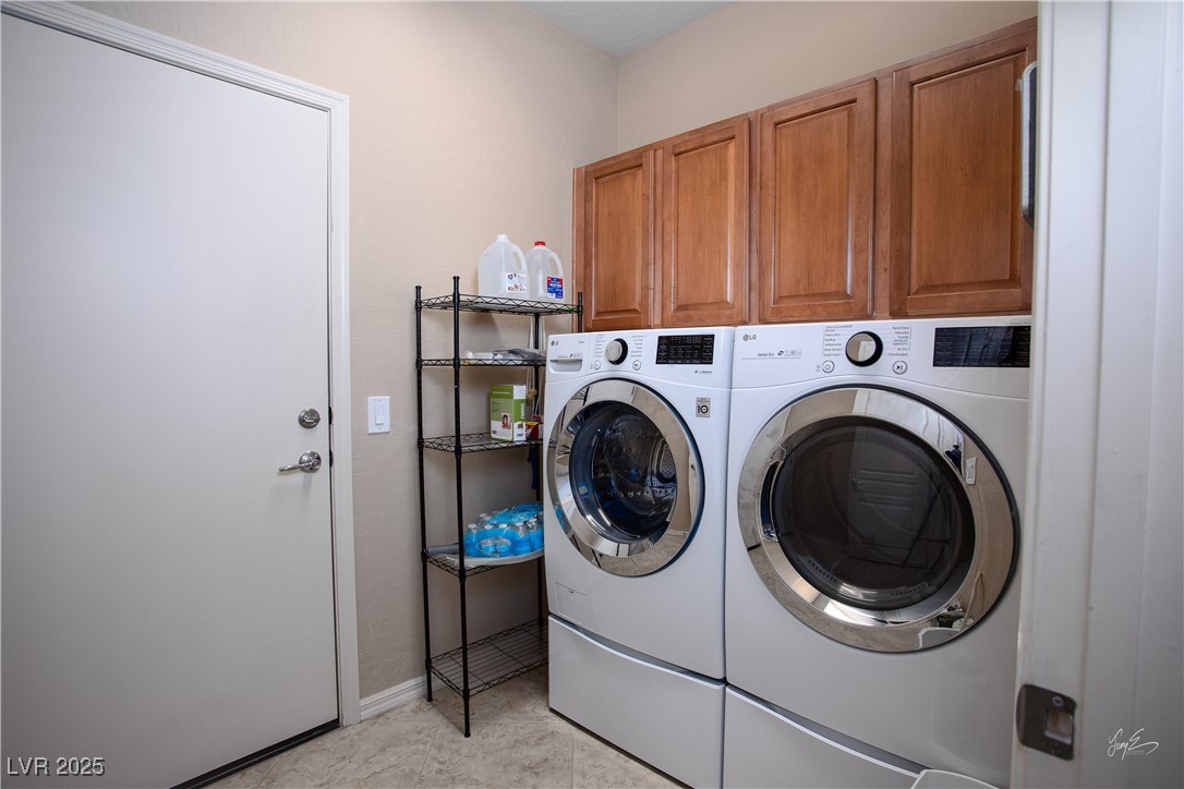 1074 Wagon Trail Mesquite, NV 89034 - Photo 20 of 27 Laundry area with washing machine and clothes dryer and cabinet space