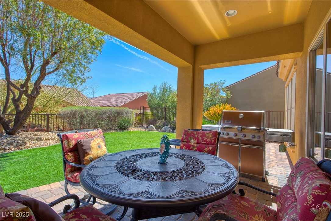1074 Wagon Trail Mesquite, NV 89034 - Photo 22 of 27 View of patio / terrace with a fenced backyard, area for grilling, outdoor dining area, and exterior kitchen