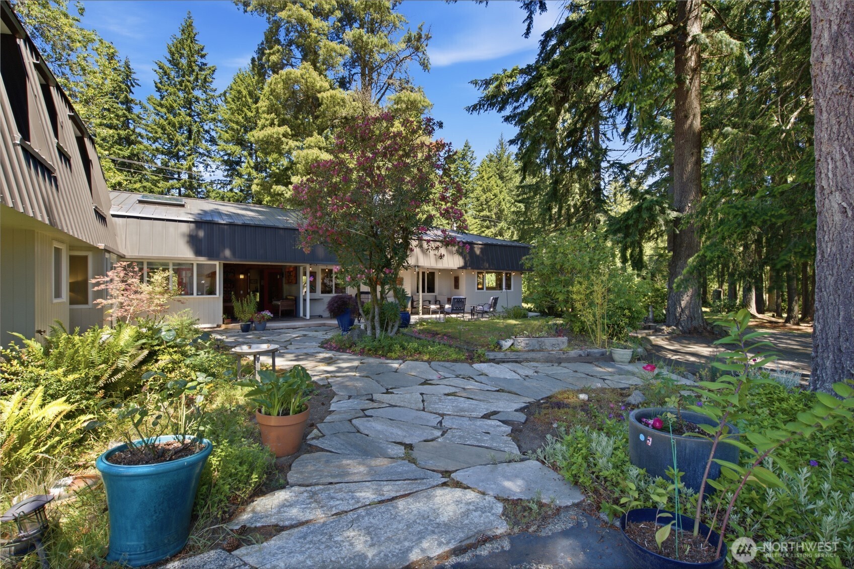 3050 Southeast Mullenix Road Port Orchard, WA 98367 - Photo 32 of 40 a view of a house with a garden and plants