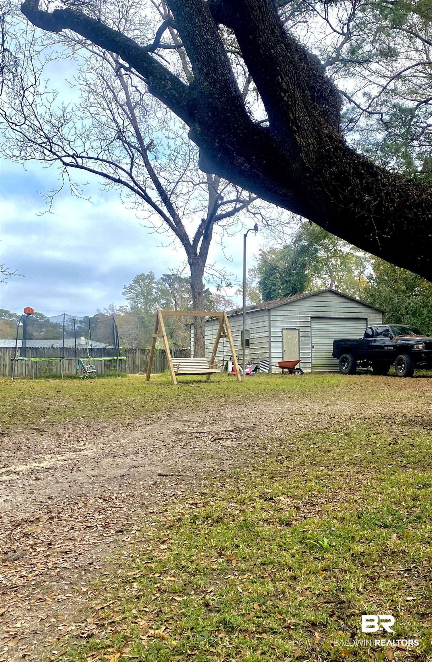 406 Cleveland Road Saraland, AL 36571 - Photo 15 of 16 View of yard featuring an outbuilding and a trampoline