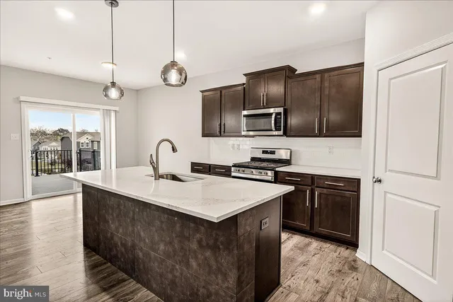 a kitchen with cabinets appliances and a counter top