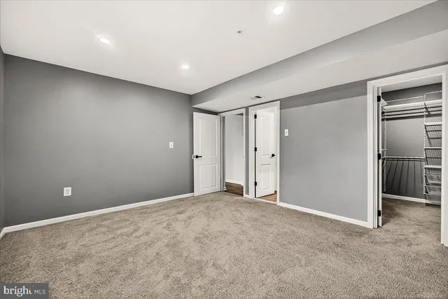 a view of walk in closet with empty racks