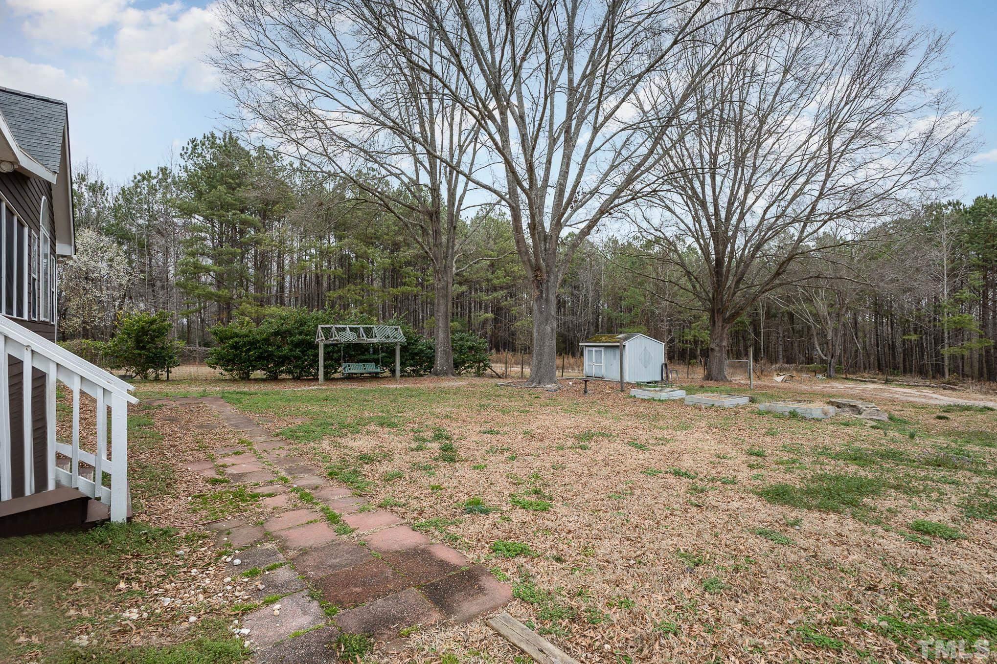 3404 Lizard Lick Road Wendell, NC 27591 - Photo 23 of 24 a view of a yard with plants and trees