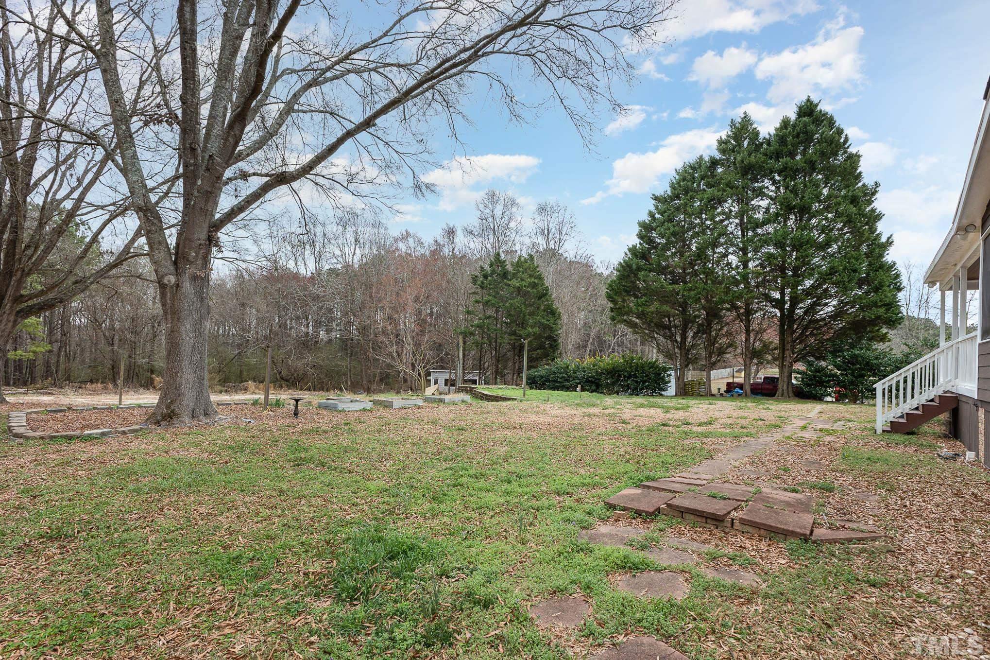 3404 Lizard Lick Road Wendell, NC 27591 - Photo 24 of 24 a backyard of a house with lots of green space