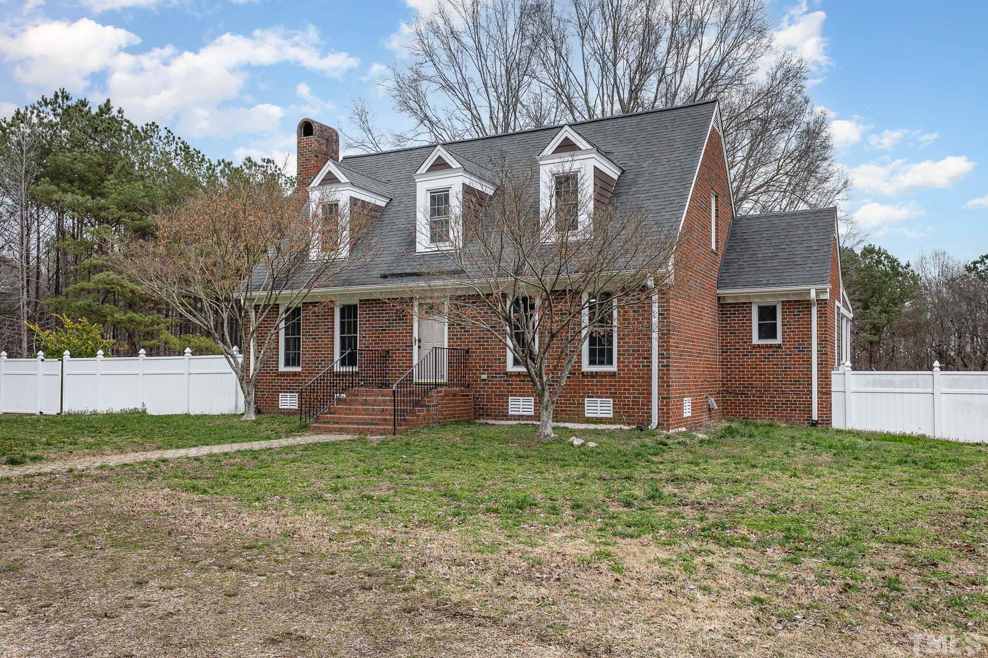 3404 Lizard Lick Road Wendell, NC 27591 - Photo 4 of 24 a front view of a house with a yard and trees