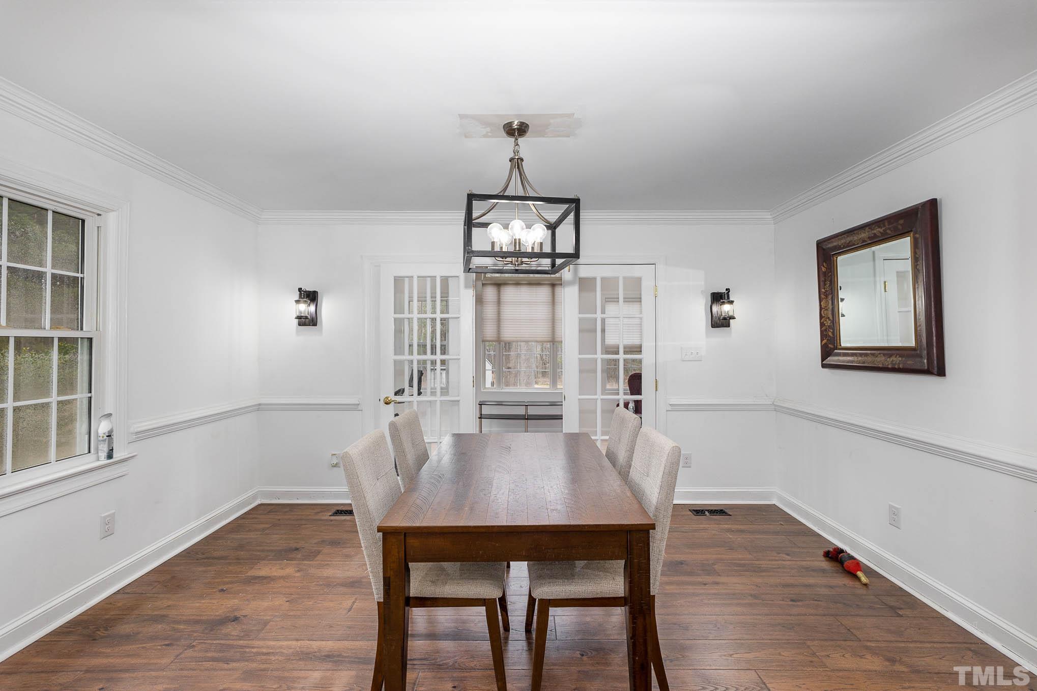 3404 Lizard Lick Road Wendell, NC 27591 - Photo 8 of 24 a view of a dining room with furniture window and wooden floor