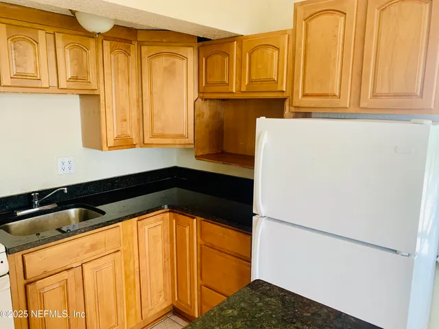 a view of a refrigerator and window