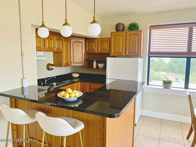a kitchen that has a table and chairs in it