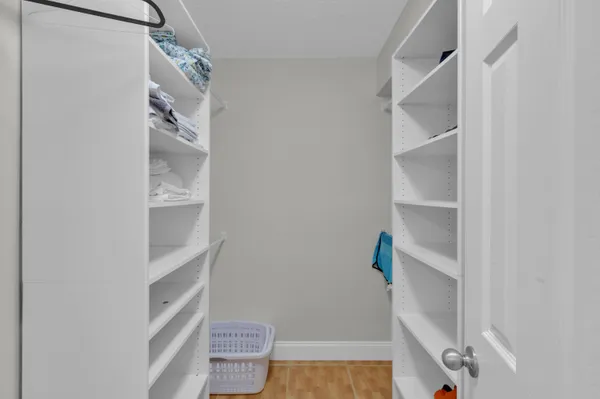 a view of walk in closet with empty racks