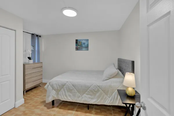 a bedroom with a bed and table