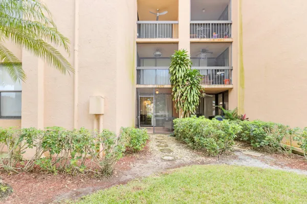 a view of a house with a yard and plants
