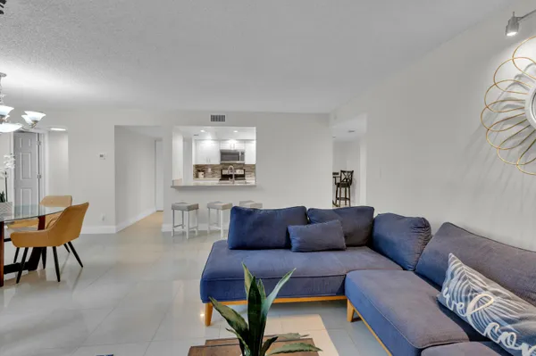 a living room with furniture a couch and a flat screen tv