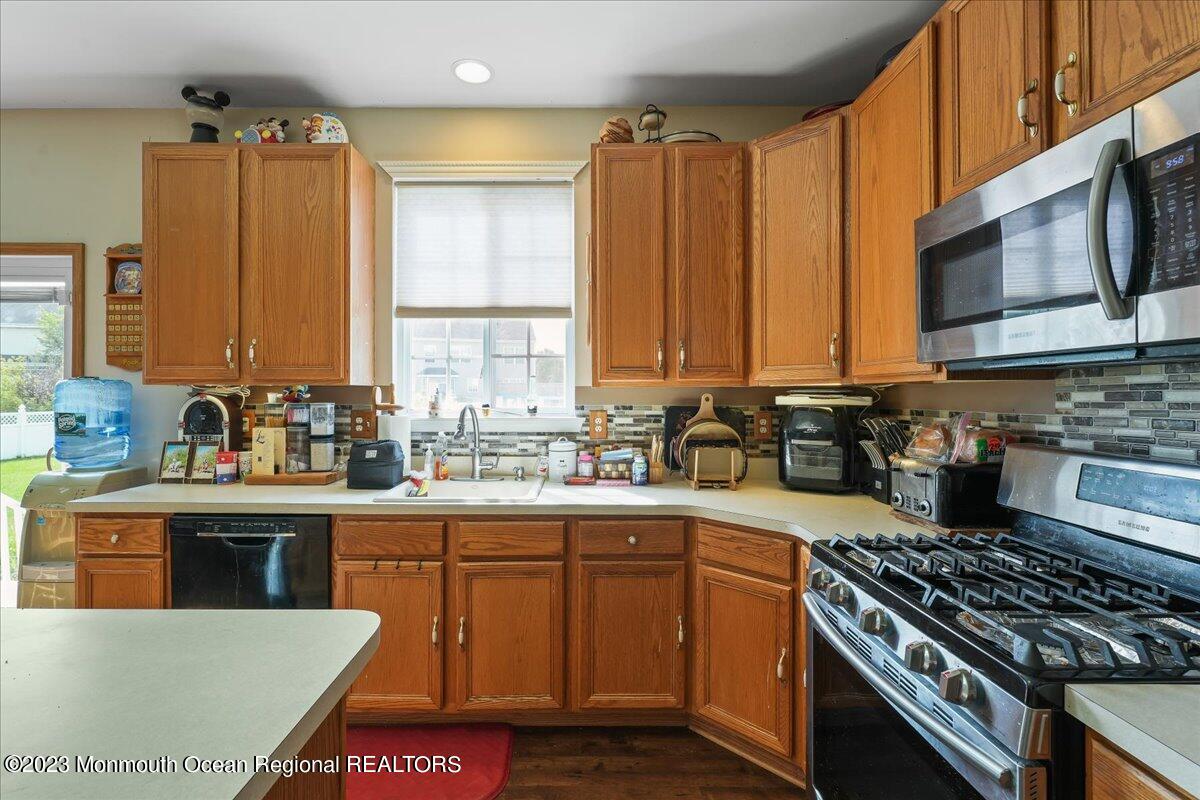 1 Chiswick Drive Jackson, NJ 08527 - Photo 13 of 48 a kitchen with stainless steel appliances a stove a sink a microwave and cabinets
