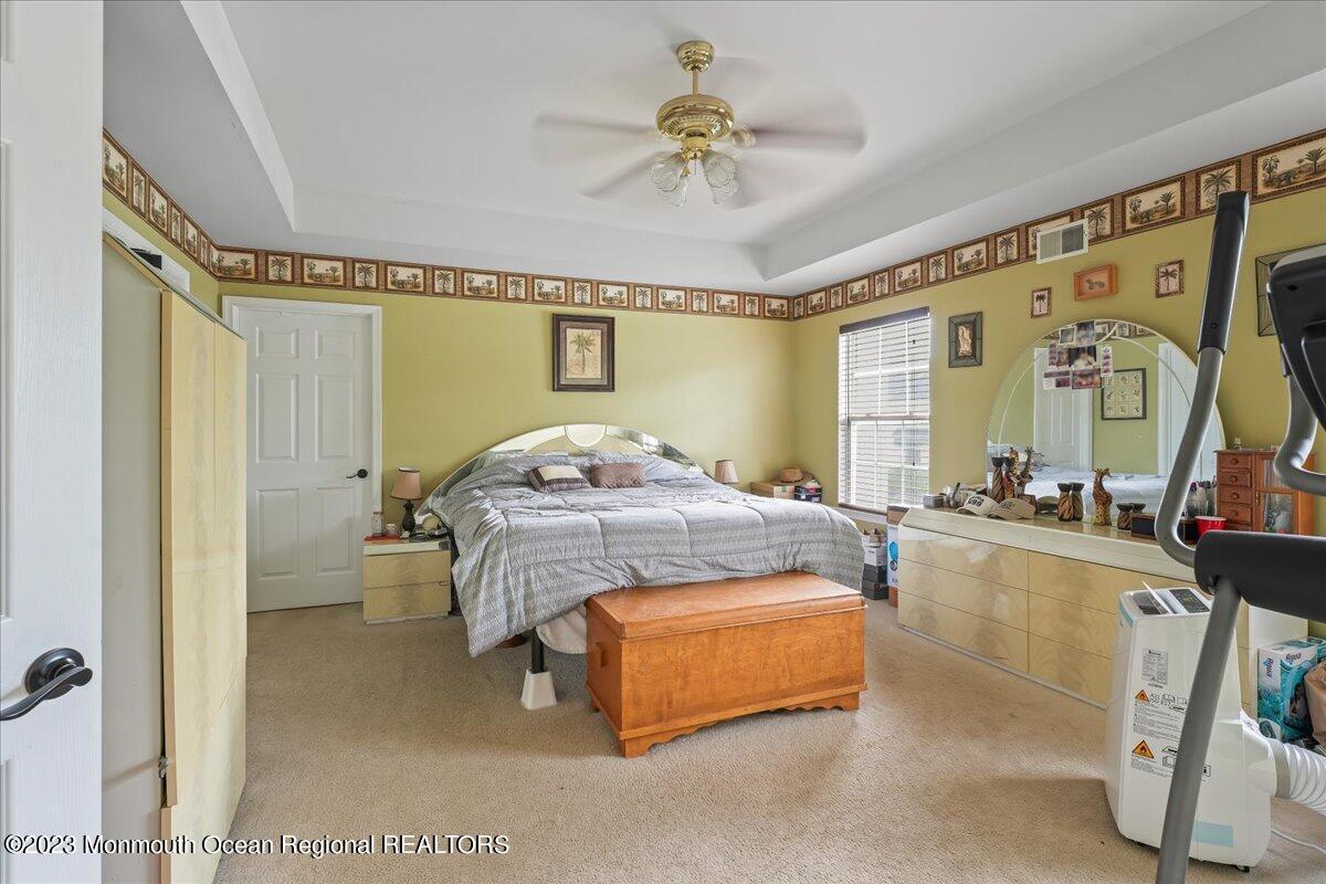 1 Chiswick Drive Jackson, NJ 08527 - Photo 31 of 48 a bedroom with a bed and a chandelier