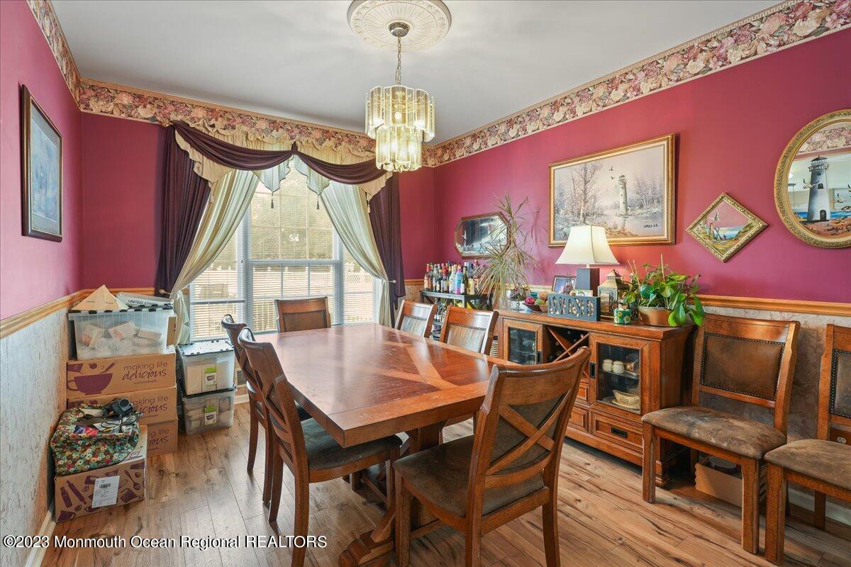 1 Chiswick Drive Jackson, NJ 08527 - Photo 8 of 48 a dining room with furniture a chandelier and wooden floor