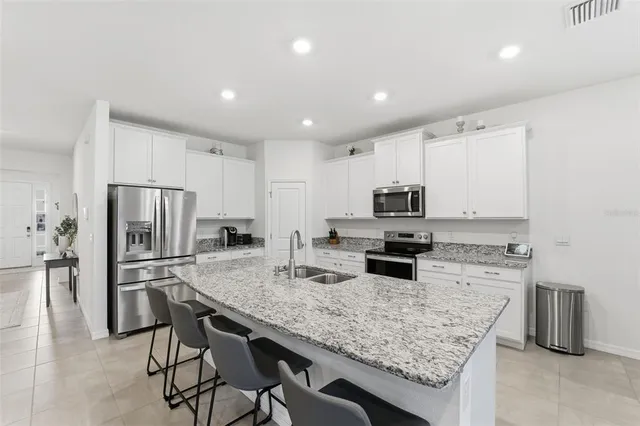 a kitchen with refrigerator and microwave