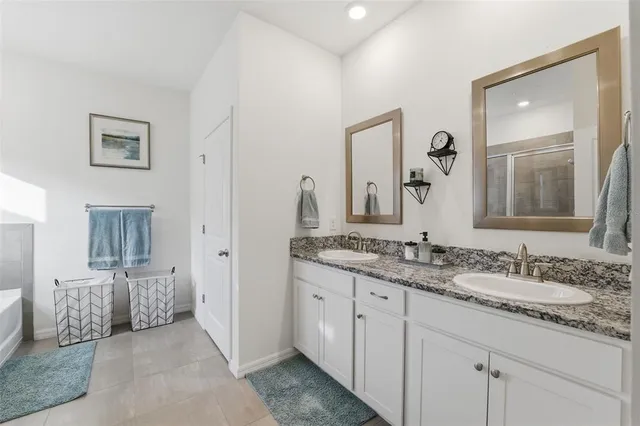 a en suite bathroom with double sink and a mirror