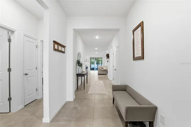 a view of a hallway with furniture and a potted plant