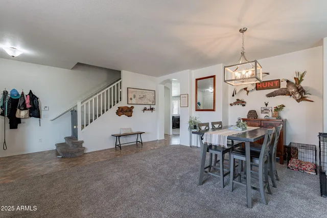 a view of a dining room with furniture and chandelier