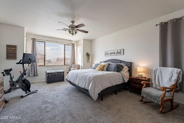 a spacious bedroom with a bed couch and a large window