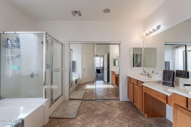 a large bathroom with a glass door shower a sink and mirror