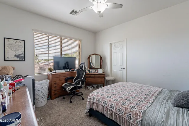 a bedroom with bed chair and window